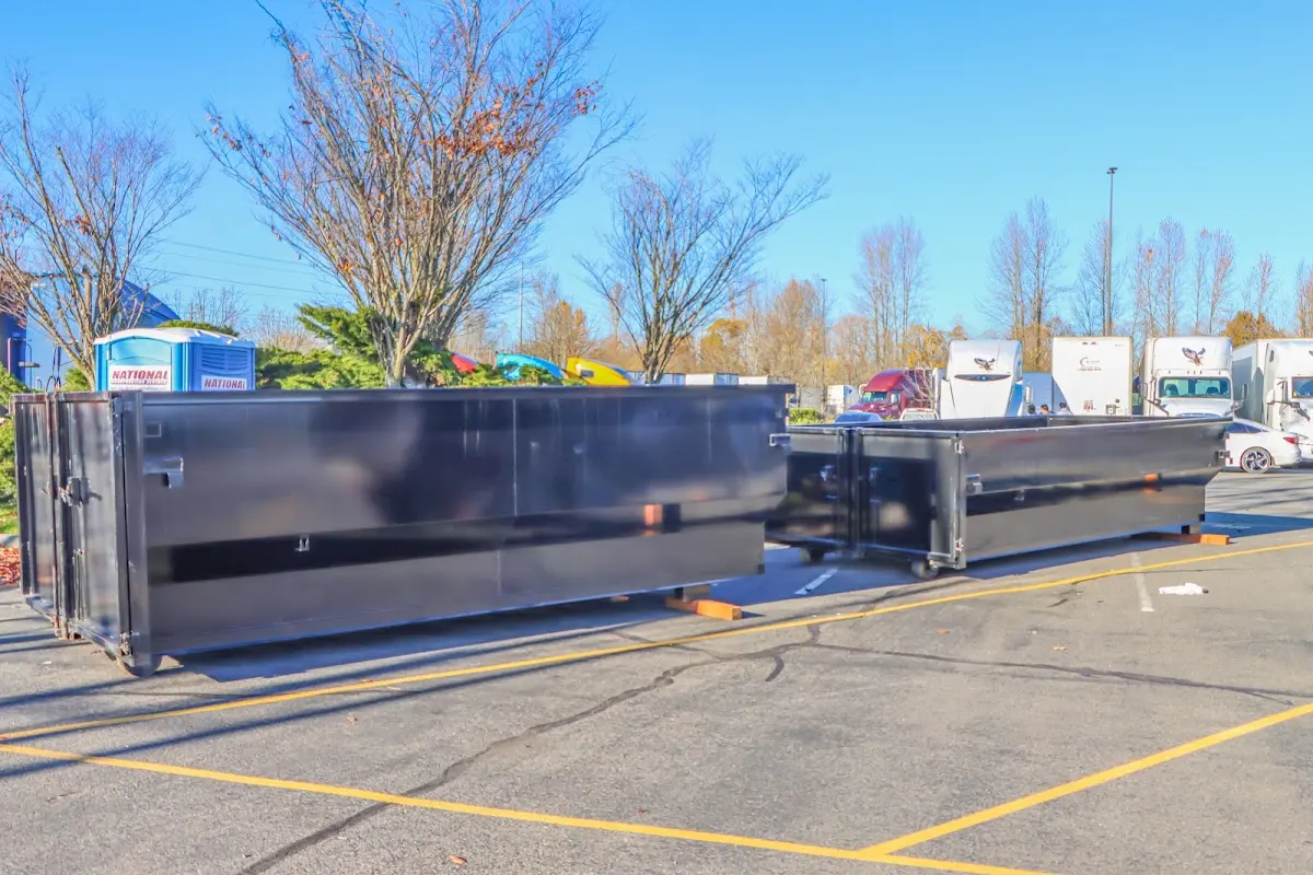 Professional dumpster rental service with roll-off container on residential driveway in Belgrade